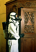 Technician about to fumigate a wooden church door