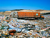 Landfill site with waste truck dumping refuse