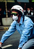 Cyclist wearing a fume mask