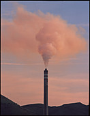 Chimney at an oil refinery with smoke coming out