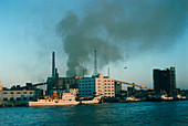 Industrial air pollution from a riverside factory
