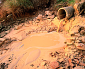 Yellow liquid industrial effluent coming from pipe