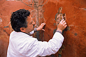 Archaeologist cleaning a fresco,Pompeii