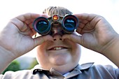 Boy using binoculars