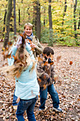 Father and children playing in a wood