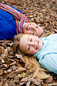 Mother and daughter on autumn leaves