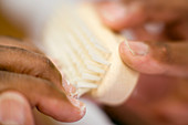 Brushing under nails