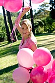 Happy Woman holding balloons