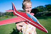 Boy playing with a model aeroplane