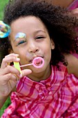 Girl blowing soap bubbles