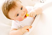 Baby boy eating a crisp