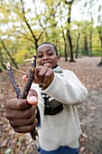 Boy playing with a catapult