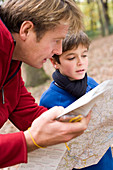 Father and son reading a map
