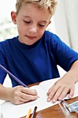 Boy drawing in an exercise book