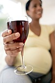 Pregnant woman with a glass of red wine