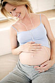 Pregnant woman listening to music