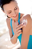 Woman applying sunscreen