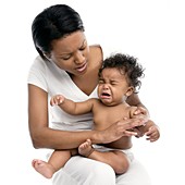 Applying skin cream to a baby