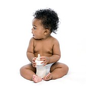Baby girl with bottle of milk