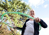 Senior woman hula-hooping