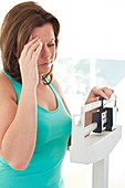 Woman weighing herself