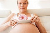 Pregnant woman with doughnuts