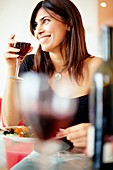 Woman drinking wine with dinner