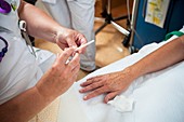 Nurse preparing a patient for an IV line