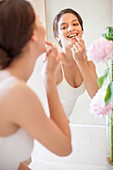 Woman applying lip balm