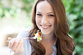 Young woman eating a salad