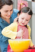 Mother and daughter baking