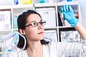 Young woman holding test tube