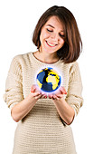Young woman with the globe in her hands