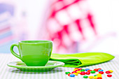 Green teacup and confectionary on a table