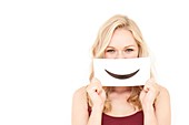 Woman holding smiley mouth