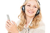 Woman wearing headphones with smartphone