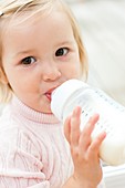 Toddler holding a bottle of milk