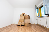 Stack of cardboard boxes in an empty room