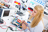 Lab assistant using a circuit board