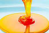Thick golden liquid being poured