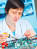 Lab assistant working on circuit board
