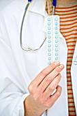 Doctor holding oral contraception pills