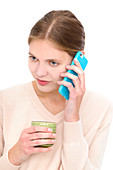 Woman on cell phone holding mug