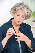 Woman using finger prick test