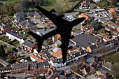 Aeroplane shadow over houses