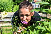 Mid adult woman smelling a flower