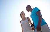 Couple holding hands on beach