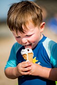 Young boy licking an ice cream