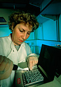 Researcher loads PCR equipment to clone foetal DNA