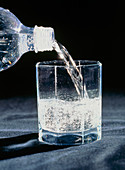 Sparkling mineral water being poured into a glass